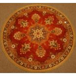 Persian design circular red ground rug, stylised central medallion,