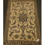 Persian Nain ivory ground with blue scrolled floral decoration,