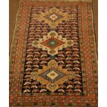 Persian multicoloured rug, field with lozenge and stylised birds within a triple repeating border,
