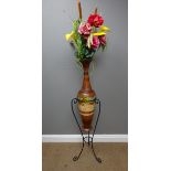 Contemporary terracotta vase with incised floral decoration on wrought metal stand,