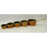 Set of five graduating copper and brass handled sauce pans,