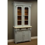 Victorian painted pine bookcase on cupboard, carved mounted corbels, enclosed by two glazed doors,