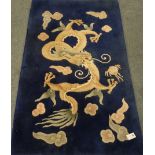 Chinese blue ground washed woollen rug, decorated with dragon,