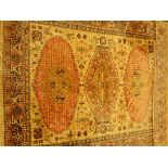 Large Persian design rug carpet, wheat ground with three lozenge medallions,