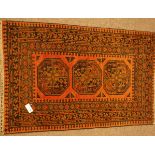 Persian Bokhara rust ground rug, decorated with triple Gul medallions,