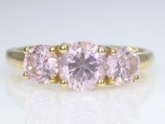 Three stone pink cubic zirconia gold ring hallmarked 14ct Condition Report size