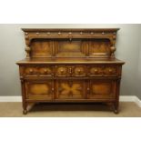 20th century carved oak sideboard, raised back with arched panels,