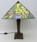 Tiffany style table lamp, with leaded and slag glass shade on a bronzed cast metal base,