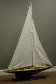 Wooden model of a yacht on stand with a metal plaque reading 'Endeavour', L112cm, W20cm,