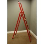 Wooden and red painted metal step ladders