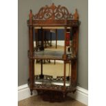 Edwardian walnut wall shelf with mirrored back and two concave shelves with fret work galleries and