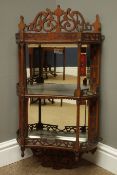 Edwardian walnut wall shelf with mirrored back and two concave shelves with fret work galleries and