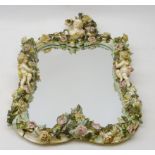 19th century Meissen style mirror, the rocaille frame heavily applied with roses amongst foliage,