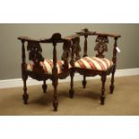 Heavily carved reproduction mahogany love seat, with masks, shells and foliage decoration,