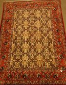 Persian red and beige ground rug, decorated with Herati and Boteh motifs,