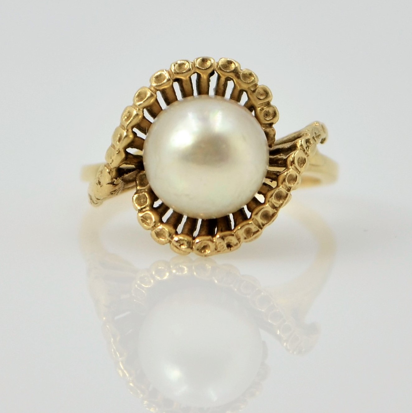 Pearl gold ring in open scroll setting tested to 9ct Condition Report size