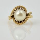 Pearl gold ring in open scroll setting tested to 9ct Condition Report size