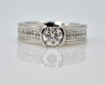 White gold diamond ring with diamond shoulders, tension set central diamond 0.