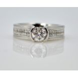 White gold diamond ring with diamond shoulders, tension set central diamond 0.