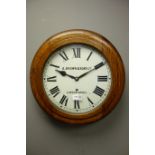Early 20th century circular oak case wall clock, white dial signed 'A.