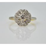 Art Deco platinum set diamond flower cluster ring on 18ct gold shank stamped 18ct.