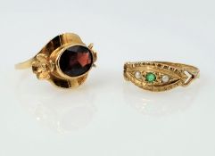 Gold garnet set ring with flower detail and a gold emerald and seed pearl ring both hallmarked 9ct