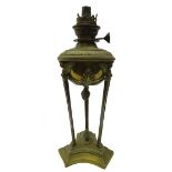 19th century French Neoclassical style brass oil lamp, decorated with three figural winged masks,