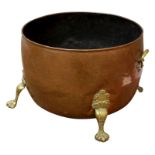 19th century circular beaten copper cauldron log bin with cast brass handles and feet,