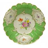 Two Meissen cabinet plates with shaped rim and hand painted floral sprays within gilt borders,