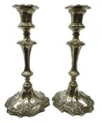 Pair Victorian Sheffield plate candlesticks with foliate scroll decoration and fluted stem,