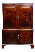 George II mahogany linen press, projecting cornice above two figured stepped ogee panelled doors,