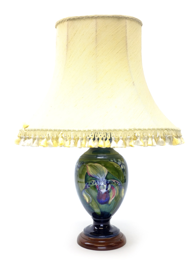 Moorcroft Orchid pattern classical shaped lamp vase on green ground and turned wood base,