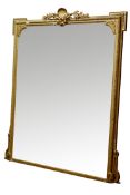 Large late 19th century gilt wood and gesso framed mirror, shell and foliage pediment with ribbon,