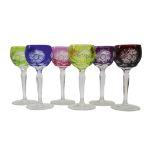 Set of six harlequin coloured overlay cut hock glasses, faceted stems and star cut base, H16.