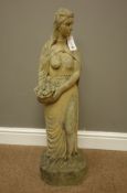 'Selby Stone' stone finish figure of a semi-nude maiden carrying basket of fruit,