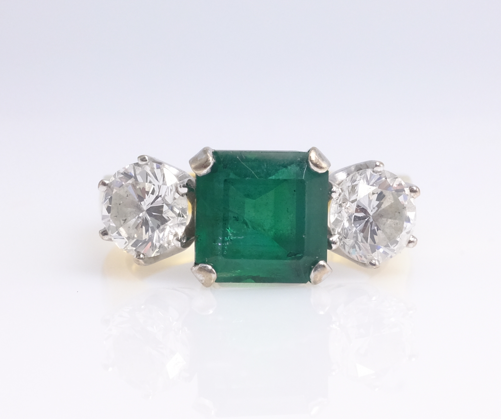Emerald and diamond three stone gold ring, hallmarked 18ct emerald approx 2 carat, each diamond 0. - Image 2 of 4