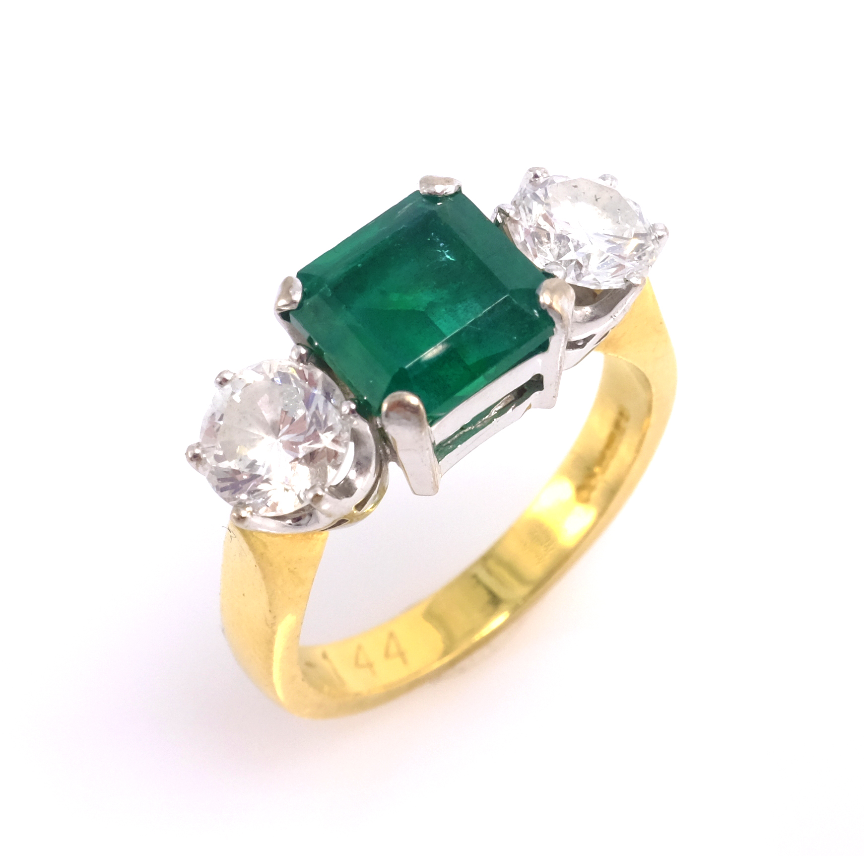 Emerald and diamond three stone gold ring, hallmarked 18ct emerald approx 2 carat, each diamond 0.