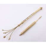 Gold engine turned toothpick and a gold swizzle stick, both hallmarked 9ct