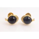 Pair of Piaget 18ct gold diamond and black onyx cuff-links, racing jockey cap design,