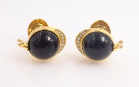 Pair of Piaget 18ct gold diamond and black onyx cuff-links, racing jockey cap design,