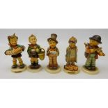 Five Goebel Hummel figures; 'Village Boy', 'Accordion Boy', 'Little Fiddler',