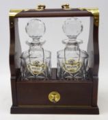 Mahogany and brass bound two bottle tantalus, with two Coalport porcelain labels,
