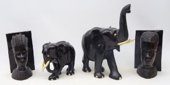Pair African carved hardwood figural bookends and two African carved ebony elephants,