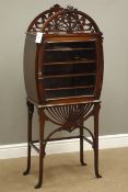 Edwardian mahogany music cabinet, arched carved and fret work pediment and apron,