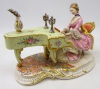 Capodimonte figure of a lady playing the piano, signed D.
