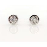 Pair of 18ct white gold rubover diamond stud ear-rings stamped 750 approx 1.