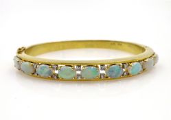 Opal and diamond gold hinged bangle, nine opals, twenty diamonds stamped 18k 750,