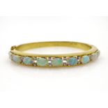 Opal and diamond gold hinged bangle, nine opals, twenty diamonds stamped 18k 750,