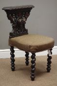 Late 19th century oak reading chair, carved with hound mask and foliage, barley twist supports,