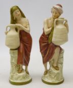Pair Royal Dux water carriers, modelled as a man & woman, H19.